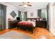Spacious primary bedroom with wood floors, soft rug, and dark wood furniture at 408 Idlewood Dr, Kannapolis, NC 28083