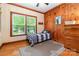 Small bedroom with wood-paneled walls, hardwood floors, and natural light from the window at 408 Idlewood Dr, Kannapolis, NC 28083
