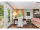 Bright dining room featuring hardwood floors, a window with curtains, and access to the backyard at 408 Idlewood Dr, Kannapolis, NC 28083