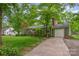 Cozy home with attached garage, green siding, mature trees, and well-maintained lawn at 408 Idlewood Dr, Kannapolis, NC 28083