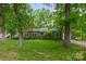 Inviting single-story home with green lawn, mature trees, and a charming front entrance at 408 Idlewood Dr, Kannapolis, NC 28083