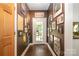 Hallway with hardwood floors, leading to a glass door, and wall decor at 408 Idlewood Dr, Kannapolis, NC 28083