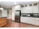 Bright kitchen featuring white cabinets, stainless steel appliances, and dark countertops at 408 Idlewood Dr, Kannapolis, NC 28083