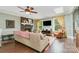 Cozy living room with brick fireplace, ceiling fan, hardwood floors, and natural light at 408 Idlewood Dr, Kannapolis, NC 28083