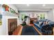 Bright living room with fireplace, exercise bike, hardwood floors, and large windows at 408 Idlewood Dr, Kannapolis, NC 28083