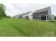 Rear view of several homes with backyard patios in a row, showing grass and a gentle slope at 4174 Charlton Rd, Fort Mill, SC 29715