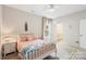 Neutral bedroom with pink accents, featuring a ceiling fan, oriental rug, and ensuite bath at 4174 Charlton Rd, Fort Mill, SC 29715