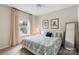 Cozy bedroom featuring a patterned duvet, ceiling fan, neutral walls and floors, and natural light from the window at 4174 Charlton Rd, Fort Mill, SC 29715