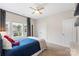 Bedroom with blue accents, featuring a ceiling fan, neutral walls and floors, and standard closet doors at 4174 Charlton Rd, Fort Mill, SC 29715