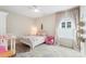 Neutral bedroom with pink accents, featuring a ceiling fan, oriental rug, and pink curtains at 4174 Charlton Rd, Fort Mill, SC 29715
