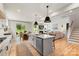 Open concept kitchen with island, stainless steel appliances, and a view to the living area at 4174 Charlton Rd, Fort Mill, SC 29715