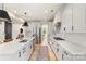 Bright kitchen features stainless steel appliances, a large island, and modern pendant lighting at 4174 Charlton Rd, Fort Mill, SC 29715