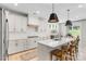 Modern eat-in kitchen with wooden chairs, island seating, and lots of natural light at 4174 Charlton Rd, Fort Mill, SC 29715