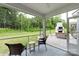 View of screened in porch with outdoor seating and fireplace in a wooded setting at 4174 Charlton Rd, Fort Mill, SC 29715