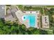 Aerial view of a community pool, surrounding building, playground and green spaces offering recreational amenities at 4313 Courtly Ln, Belmont, NC 28012