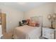 Cozy bedroom featuring neutral tones, a metal headboard, and a quaint desk area for work or study at 4313 Courtly Ln, Belmont, NC 28012