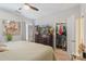 Well-lit bedroom features a dresser with a TV, and an open closet, offering both entertainment and storage options at 4313 Courtly Ln, Belmont, NC 28012