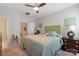 Spacious bedroom with a ceiling fan, carpeted floor, and a cozy bed, offering a comfortable retreat at 4313 Courtly Ln, Belmont, NC 28012