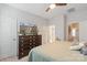 Bedroom with a flat-screen TV atop a dresser, adjacent to a bathroom and a closet door, perfect for storage at 4313 Courtly Ln, Belmont, NC 28012