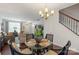 Cozy dining area with glass table next to staircase and living area at 4313 Courtly Ln, Belmont, NC 28012