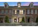 Charming brick townhome with dormers, black shutters, tasteful landscaping and a white picket fence at 4313 Courtly Ln, Belmont, NC 28012