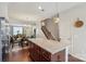 Open concept kitchen with granite island, connecting dining, and living spaces at 4313 Courtly Ln, Belmont, NC 28012