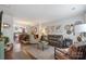 Open-concept living room with elegant furnishings seamlessly connects to the dining area and kitchen at 4313 Courtly Ln, Belmont, NC 28012