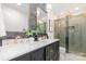 Modern bathroom with double sinks, marble countertop, and a glass-enclosed shower with gold hardware at 437 Chadmore South Dr, Charlotte, NC 28270