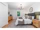 Bright bedroom with a large window, chandelier, stylish rug, and decorative bedside tables at 437 Chadmore South Dr, Charlotte, NC 28270