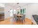 Cozy dining area featuring a modern chandelier, a wood table with gray chairs and natural light at 437 Chadmore South Dr, Charlotte, NC 28270