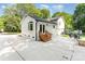 Charming white home exterior with a wooden staircase, a large yard, and an inviting patio area at 437 Chadmore South Dr, Charlotte, NC 28270