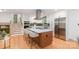 Modern kitchen with stainless steel appliances, white cabinetry, and a large center island with bar seating at 437 Chadmore South Dr, Charlotte, NC 28270