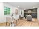 Bright living room with a decorative fireplace, neutral furniture, and large windows with natural light at 437 Chadmore South Dr, Charlotte, NC 28270