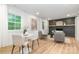 Open-concept living room featuring hardwood floors, a modern fireplace, and comfortable seating at 437 Chadmore South Dr, Charlotte, NC 28270