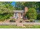 The backyard has a wooden deck with outdoor furniture, a brick chimney, and trees at 4424 Huntington Dr, Gastonia, NC 28056