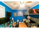 A vibrant blue bedroom featuring a bunk bed, gaming setup, and hardwood floors at 4424 Huntington Dr, Gastonia, NC 28056