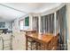 Bright dining area features a wooden table with seating for four, tile floor, and gray curtains at 4424 Huntington Dr, Gastonia, NC 28056