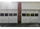 Spacious two-car garage with white doors, a brick column, and windows for natural lighting at 4424 Huntington Dr, Gastonia, NC 28056
