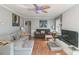 A bright living room with hardwood floors, neutral walls, a brick fireplace and comfortable sofas at 4424 Huntington Dr, Gastonia, NC 28056