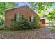This brick house features a lush, landscaped foundation and classic black shutters at 4424 Huntington Dr, Gastonia, NC 28056