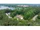 Breathtaking aerial view of a house nestled in lush greenery, near the tranquil waterfront and lake at 4616 Gold Finch Dr, Denver, NC 28037