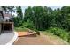 Picturesque backyard with a stone patio, built-in seating, and a tranquil wooded backdrop at 4616 Gold Finch Dr, Denver, NC 28037