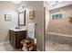 Bright bathroom featuring neutral vanity, walk-in shower with tile surround, and decor at 4616 Gold Finch Dr, Denver, NC 28037