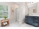 Bright bathroom featuring a glass-enclosed shower and gray vanity at 4616 Gold Finch Dr, Denver, NC 28037