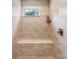 Walk-in shower with a built-in bench seat, neutral tile and natural light from window at 4616 Gold Finch Dr, Denver, NC 28037