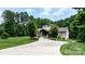 Beautiful brick home with manicured lawn and a long driveway bordered by trees, offering curb appeal and charm at 4616 Gold Finch Dr, Denver, NC 28037