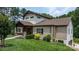 Beautiful brick home with well-manicured lawn and inviting front porch with stone and wood accents at 4616 Gold Finch Dr, Denver, NC 28037