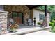 Charming front porch featuring stone pillars, wood doors, and decorative plants, creating a welcoming entrance at 4616 Gold Finch Dr, Denver, NC 28037