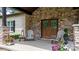 Inviting front porch featuring a stone facade, double doors, and charming outdoor seating at 4616 Gold Finch Dr, Denver, NC 28037