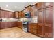 Well-lit kitchen featuring wood cabinets, granite countertops, and stainless steel appliances at 4616 Gold Finch Dr, Denver, NC 28037